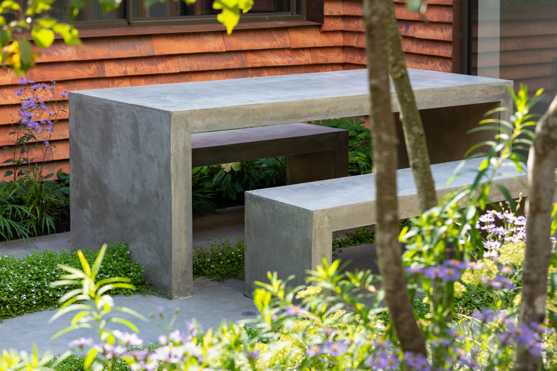 Colm Joseph Cambridge garden designers concrete table and benches perennial planting design concrete paving multi-stem crab apple tree